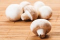 Bunch of champignon mushrooms on bamboo plate Royalty Free Stock Photo