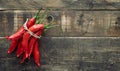 Bunch of chillies on rustic wooden background. Copy space