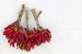 Bunch of red chillies, hot peppers on the white wall