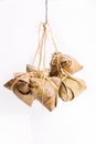 Bunch of Chinese rice dumpling tied hanging against white background in portrait orientation Royalty Free Stock Photo