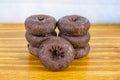 Chocolate Glazed Donuts On A Wooden Table