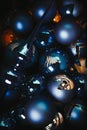 Bunch of Christmas balls in deep blue and orange shades with few broken ones
