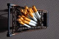 A bunch of cigarettes lying in a metal mini cart