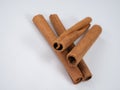 A bunch of cinnamon sticks on a white background. Cinnamon sticks are a very fragrant brown spice. Close-up and there is