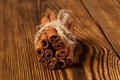 A bunch of cinnamon tied with a rope on a wooden background Royalty Free Stock Photo