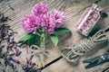 Bunch of clover, bottle with dried herb and jute rope