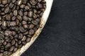 Bunch of Coffee Beans in Natural Banana Leaf Plate on Black Stone Background Surface Royalty Free Stock Photo