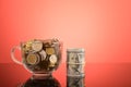 Bunch of coins and money banknote on the table over red background Royalty Free Stock Photo