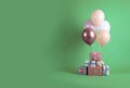 Bunch of color balloons and beautifully wrapped gift boxes on green background. Space for text Royalty Free Stock Photo