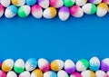 Bunch of colorful eggs on a blue Easter background 3D Rendering. Pile of birght and colorful Easter Eggs - 3d render. Easter