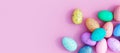 Bunch of colorful eggs on a pink Easter background