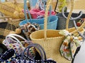 A bunch of colorful handmade straw tote bags on display