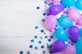 Bunch of colorful party balloons with paper stars on white wooden background Royalty Free Stock Photo