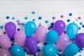 Bunch of colorful party balloons with paper stars on white wooden background Royalty Free Stock Photo