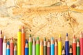 Bunch of colorful pencils, on flakeboard surface Royalty Free Stock Photo