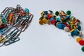 Bunch of colorful thumbtacks and many multi-colored paper-clips organize desktop and home office supplies as well as paperwork Royalty Free Stock Photo