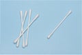 bunch cotton swabs one alone blue background