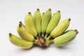 Bunch of Cultivated bananas or Thai bananas on white wooden background Royalty Free Stock Photo