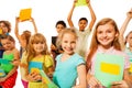 Bunch of cute girls and boys holding textbooks Royalty Free Stock Photo