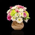 Bunch different flowers in clay vase