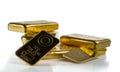 A bunch of different gold bullion isolated on a white background.