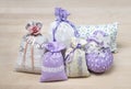 Bunch of different scented sachets for decoration on wooden board. Many fragrant pouches on table. Aromatic potpourri set.