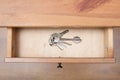 Bunch of door keys on ring in open drawer Royalty Free Stock Photo