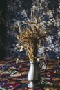 Bunch of dried wheat ears in a decorative metal vase at home Royalty Free Stock Photo