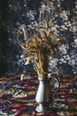 Bunch of dried wheat ears in a decorative metal vase at home Royalty Free Stock Photo