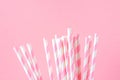 Bunch of Elegant White Striped Paper Drinking Straws on Pink Background. Birthday Party Babyshower Invitation Card Fun Kids