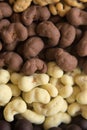 A bunch of few types of chocolate covered nuts