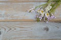 Bunch of fieldflowers,daisies, buttercups, Pentecostal flowers, dandelions on a oldwooden background with empty copy space Royalty Free Stock Photo