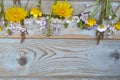 Bunch of fieldflowers,daisies, buttercups, Pentecostal flowers, dandelions on a oldwooden background with empty copy space Royalty Free Stock Photo