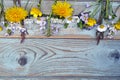 Bunch of fieldflowers,daisies, buttercups, Pentecostal flowers, dandelions on a oldwooden background with empty copy space