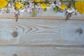 Bunch of fieldflowers,daisies, buttercups, Pentecostal flowers, dandelions on a oldwooden background with empty copy space