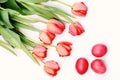 Bunch of flowers near pink Easter eggs. Bouquet of tulips Royalty Free Stock Photo