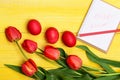 Bunch of flowers near pink Easter eggs near notebook Royalty Free Stock Photo