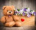 Bunch of flowers and a teddy bear