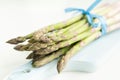 Bunch of fresh asparagus on a blue wooden cutting board Royalty Free Stock Photo