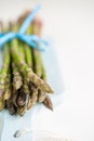 Bunch of fresh asparagus on a blue wooden cutting board Royalty Free Stock Photo