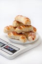 A bunch of fresh baked crescent rolls on a kitchen digital scale Royalty Free Stock Photo