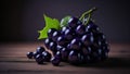 bunch of fresh black grapes on a wooden table, dark background Royalty Free Stock Photo