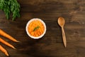 Bunch of fresh carrots with green leaves on wooden . Cooking carrot salad. Royalty Free Stock Photo
