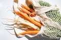 bunch of fresh carrots and parsley in an eco bag. Zero waste, plastic free concept. Sustainable lifestyle. Reusable cotton and