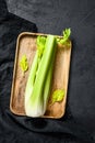 Bunch of fresh celery stalk with leaves. Black background. Top view Royalty Free Stock Photo