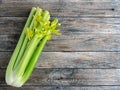 Bunch of fresh celery stalk with leaves on rustic wooden background. Organic celeriac. Healthy and vegetarian food, diet concept. Royalty Free Stock Photo