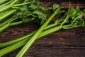 Bunch of fresh celery stalk with leaves on wooden background Royalty Free Stock Photo