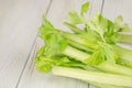 Bunch of fresh celery stalk with leaves on a wooden background Royalty Free Stock Photo