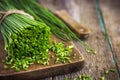 Bunch of fresh chives on a wooden cutting board