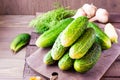 A bunch of fresh cucumbers, dill and garlic on a wooden table Royalty Free Stock Photo